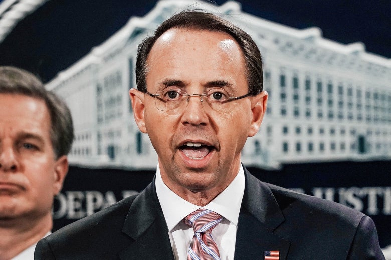Rosenstein speaking, with the DOJ logo behind him.